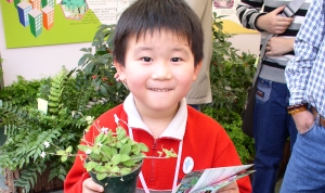 child presented with a pot plant